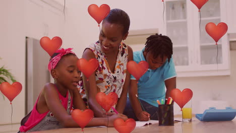 red heart balloons animation over family drawing together in kitchen
