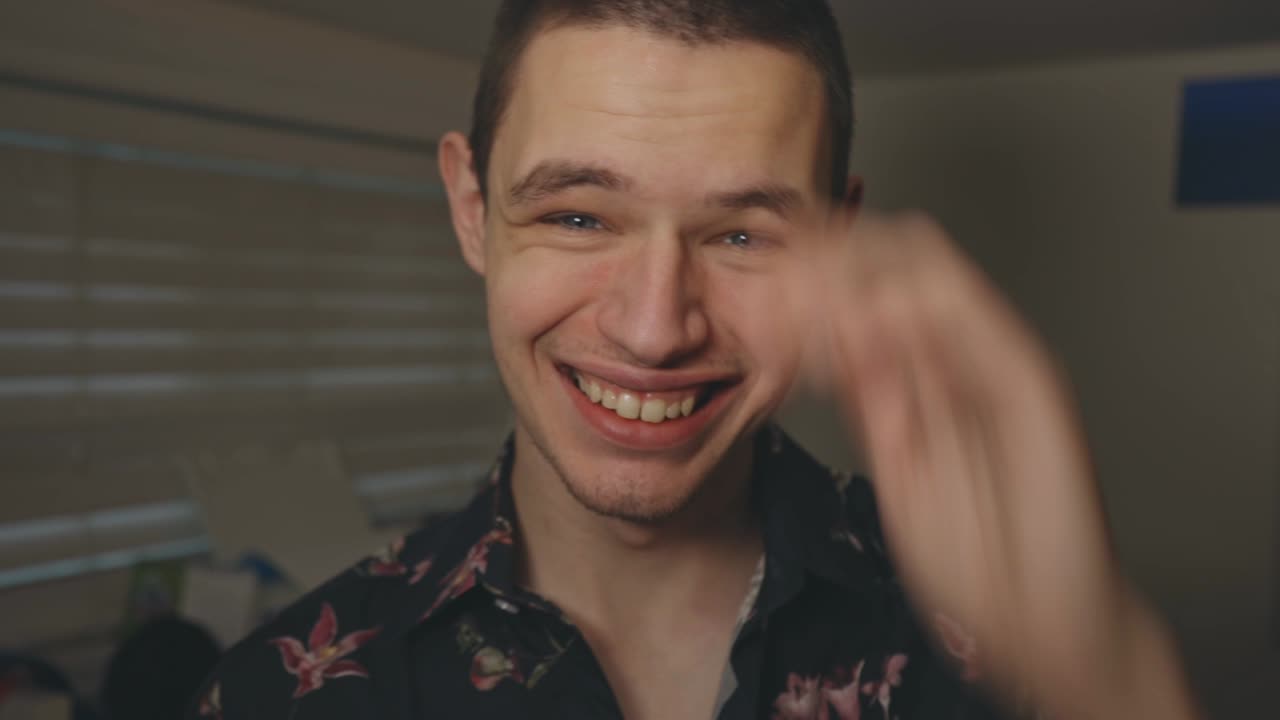 Happy Young Man With A Bright Smile Winking While Looking At The Camera - Closeup Shot