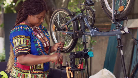 Female-cyclist-arranging-bicycle-tools