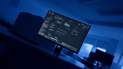 data display on a monitor in a blue-lit office environment