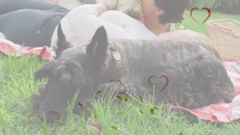 animation of hearts and confetti over caucasian female couple with their pet dogs