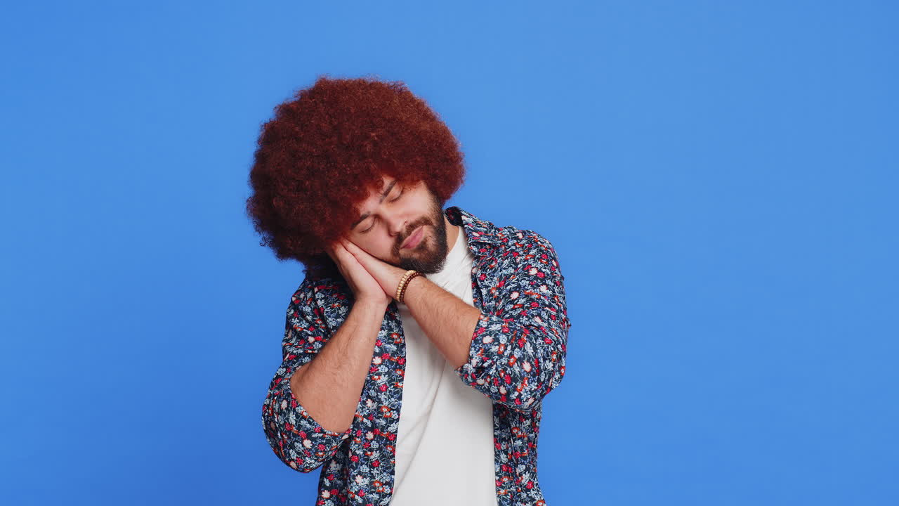 Tired exhausted young man yawning lazy bored lack of sleep falling asleep taking a break relaxing