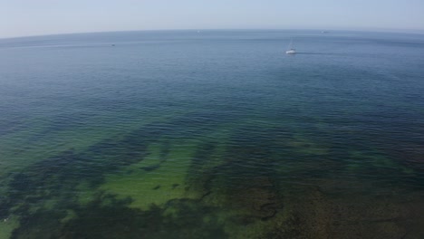 Aerial-Pan-footage-from-Poça-beach-in-São-João-Estoril,-Cascais,-Portugal