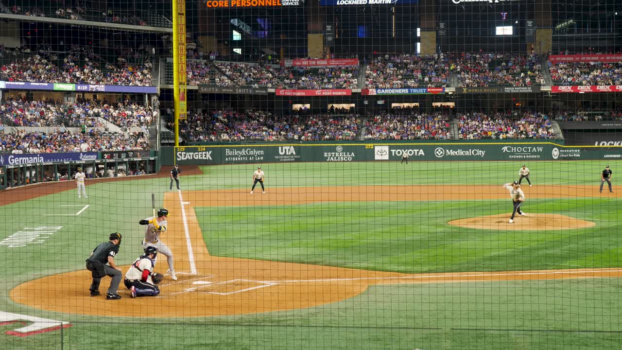 Professional baseball player missing ball at Texas Rangers home game with crowd in stands at Arlington Globe Life Field Texas USA America sports major league match