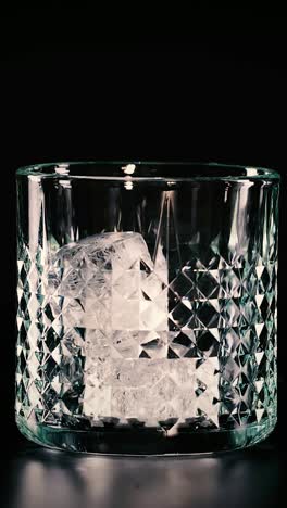 ice cube falls into an empty glass