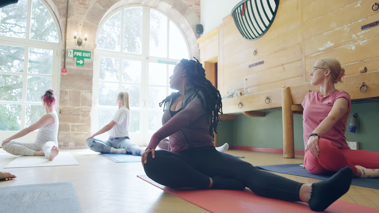 Yoga class with women practicing poses