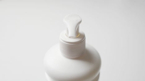 man applying moisturizing cream on his palm from a pump dispenser