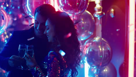 Sweet-couple-hugging-on-neon-lamps-background.-Man-and-woman-dancing-in-club