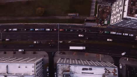 drone top down trucking shot of white truck and vehicles driving along city road