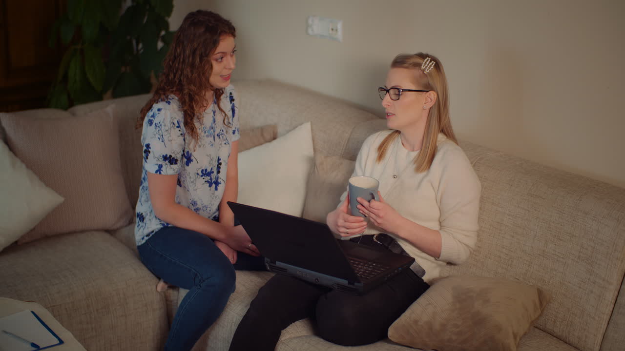 To kvinder, der diskuterer noget på en bærbar computer