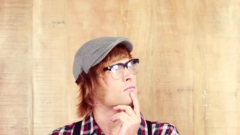 hipster thinking with hand on chin