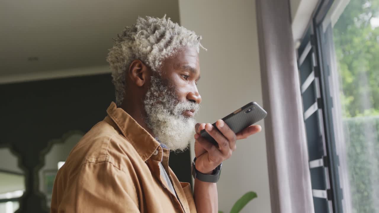 Video of african american senior man using smartphone