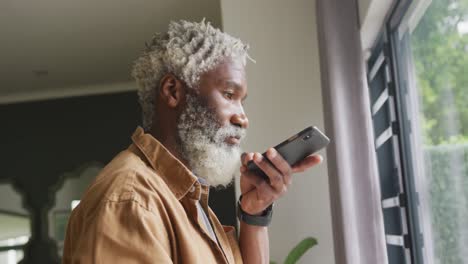 Video-of-african-american-senior-man-using-smartphone