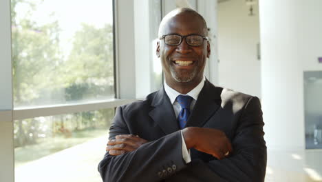 portrait of businessman walking towards camera and smiling