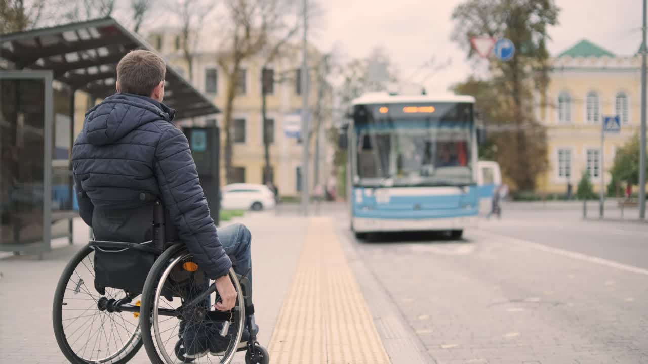 Person with a physical disability stops public transport with an accessible ramp