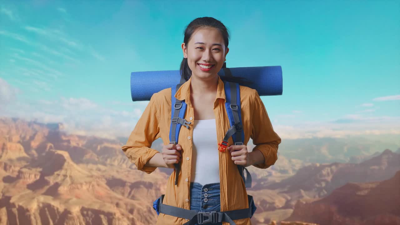 Asian Female Hiker With Mountaineering Backpack Smiling To Camera While Traveling At The Top Of Mountain