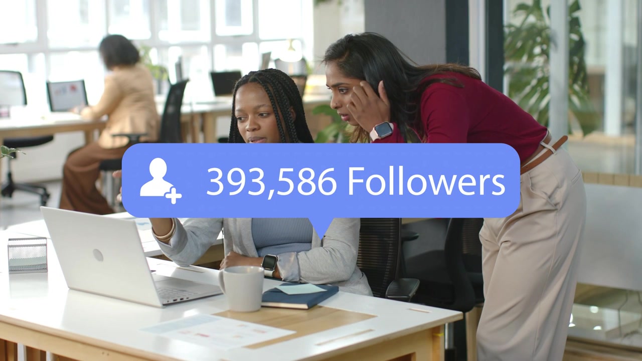 Coworkers monitoring laptop while blue bubble updating and revealing follower surge for marketing
