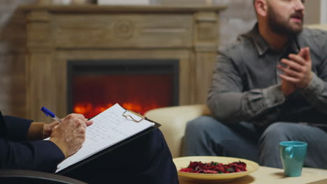 marriage counselor taking notes while giving relationship guidance