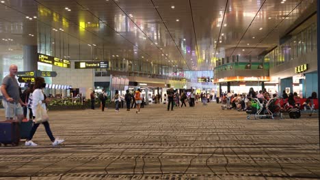 passengers moving through a busy airport terminal