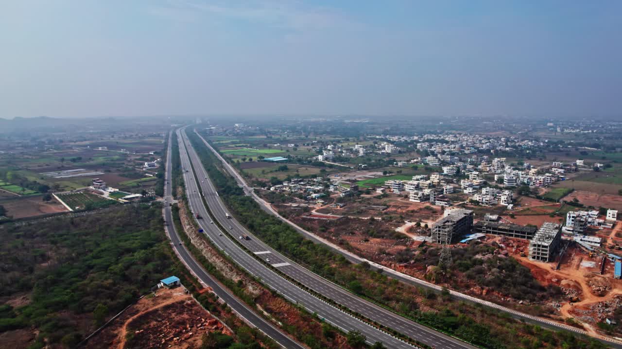 nehru outer ring road, residential buildings with blue sky hyderabad, telangana. day time semi orbit drone shot.