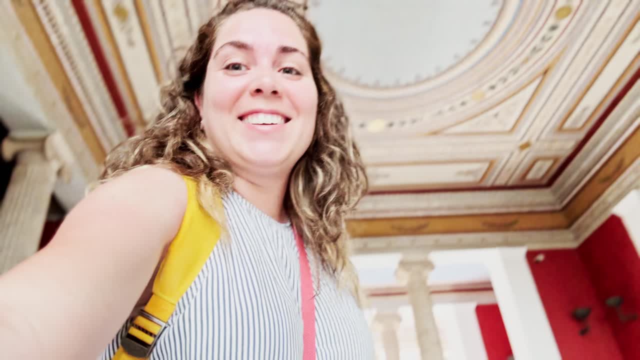 Young Woman Admiring Zappeion Hall's Ornate Ceiling