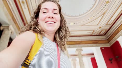 young woman admiring zappeion hall's ornate ceiling