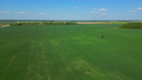 A-Smooth-Shot-of-A-Green-Field-Landscape-On-A-Clear-Weather-And-A-Semi-Cloudy-Sky