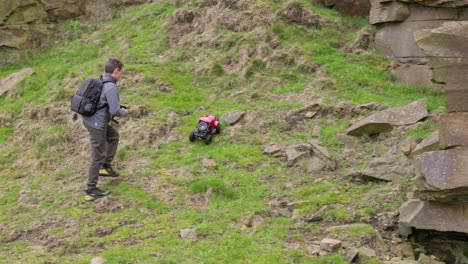 Young-boy-outdoors-on-the-moors-playing-with-his-RC-Car,-Truck,-4-x-4