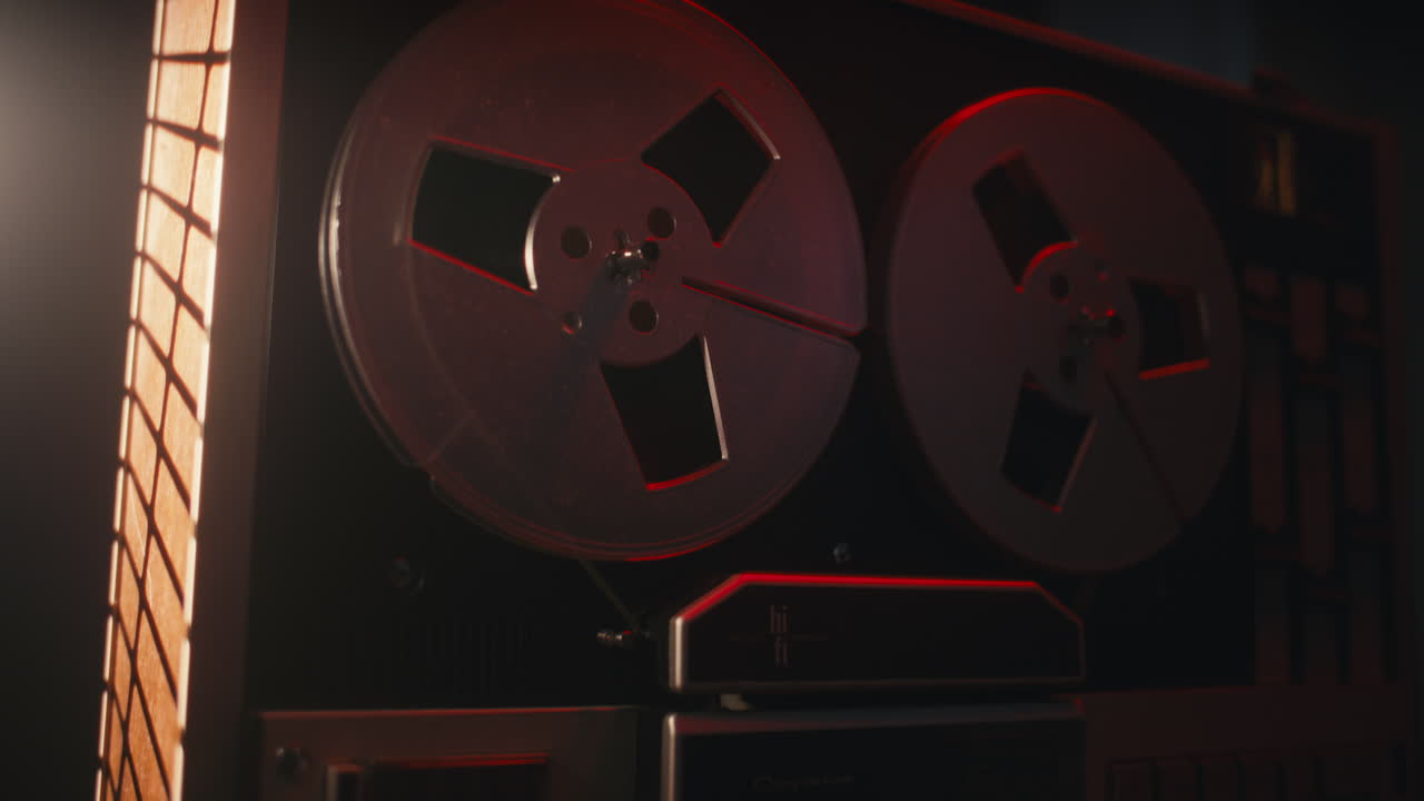 A vintage tape recorder in a red blinking light