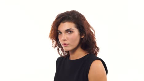 Closeup-view-of-a-depressed-young-woman-in-black-dress-looking-at-the-camera-isolated-on-white-background