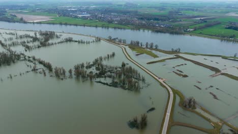 aerial view of farms and countryside flooded after severe weather has pummelled the netherlands and the waal river has overrun its banks