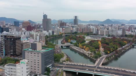 aerial view of atomic bomb dome (hiroshima peace memorial) and peace memorial park in city of hiroshima, autumn scenery with colorful trees - landscape panorama of japan from above, asia