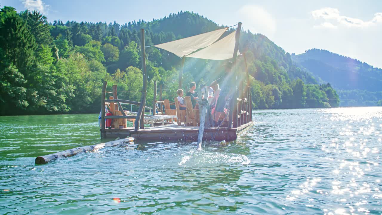 Family Enjoys Relaxing Afternoon Drinking Wine On Raft. Drava River, Muta, Slovenia