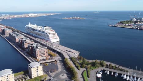 elegant cruiser parked in modern langelinie dock next to marina on bright summer day in copenhagen, aerial view