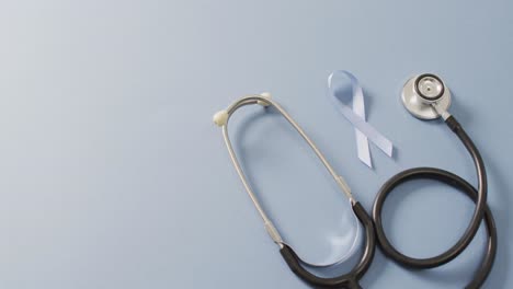 Video-of-stethoscope-and-pale-blue-prostate-cancer-ribbon-on-pale-blue-background