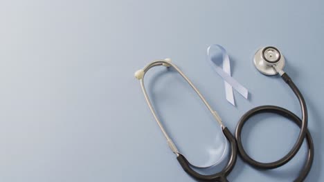video of stethoscope and pale blue prostate cancer ribbon on pale blue background
