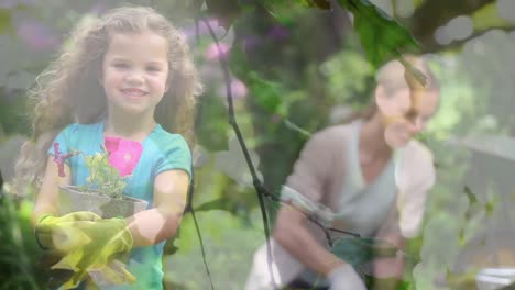 Video-of-blue-lights-over-smiling-caucasian-girl-and-woman-working-in-the-garden