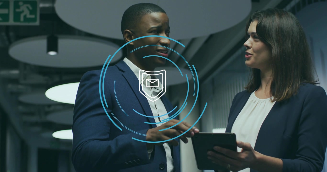 Business team tapping tablet generating hologram shield mail icon pulsing rings for email security