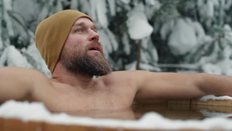 Caucasian-man-during-the-winter-bath-in-tube-outdoors.