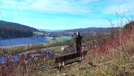 Hiker-taking-a-photo-of-a-beautiful-landscape