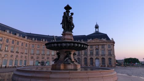 fountain of the three graces at place de la bourse in bordeaux during sunrise with nobody