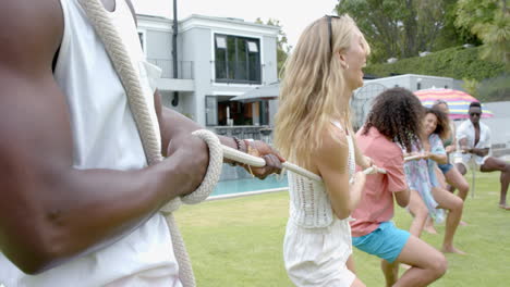 diverse group of friends enjoy a tug-of-war game outdoors