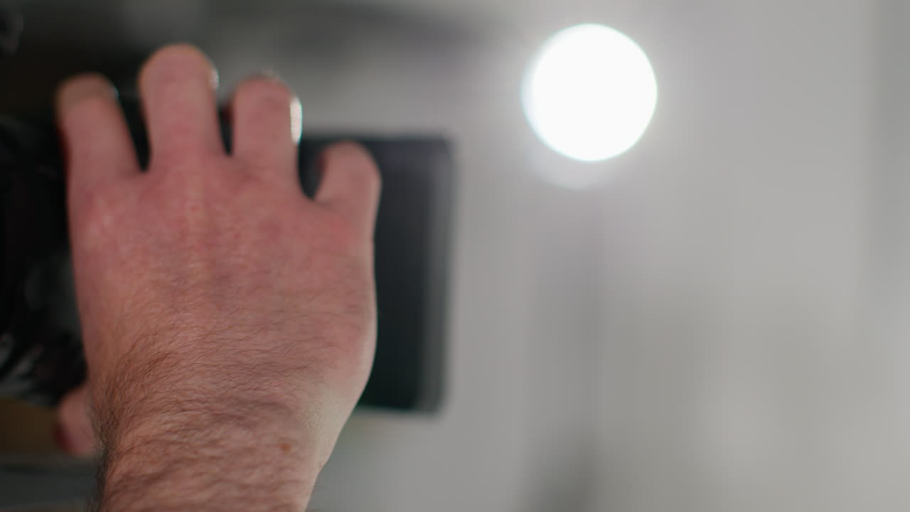 Close Up Of Male Film Camera Operator Focusing Lens On Camera Shooting Movie Or Video In Studio