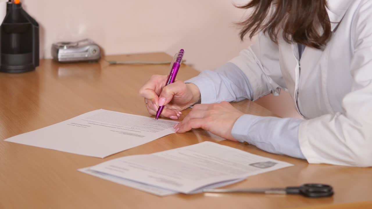 Doctor filling out patient form