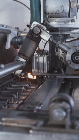 automatic machine for the production of marshmallows. rotating shaft and pistons of an automatic conveyor machine in a confectionery factory. vertical video