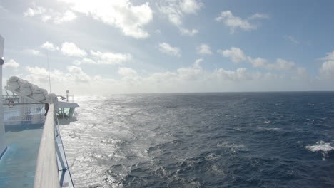 view from starboard bow of ferry as it crosses sea on bright day, wide