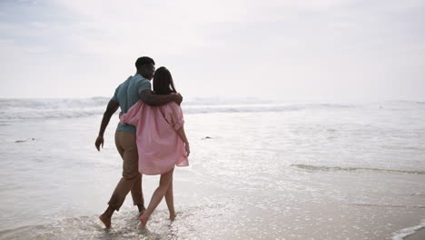 a couple enjoying a romantic walk on the beach
