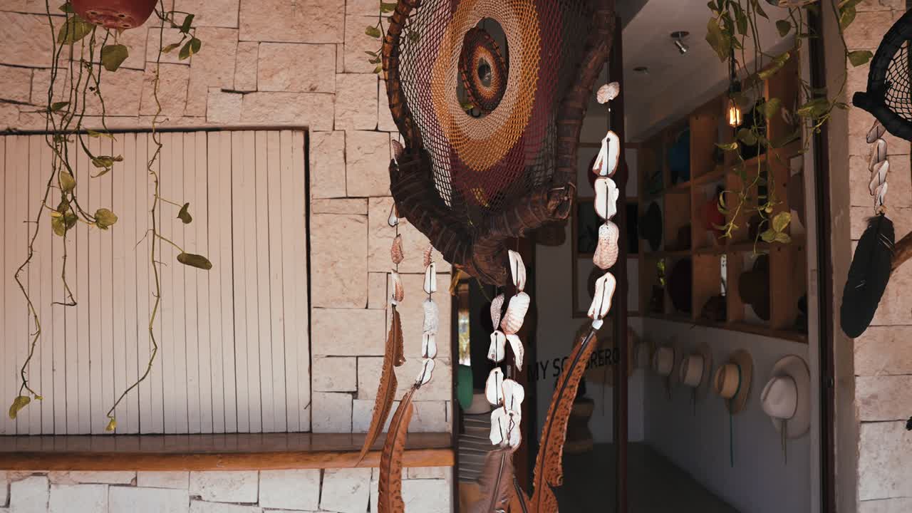 Feathers amulet Dream catcher with white feathers flying in wind sun.