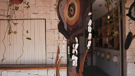 feathers amulet dream catcher with white feathers flying in wind sun.