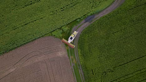 aerial view of a combine harvester working in a field of crops